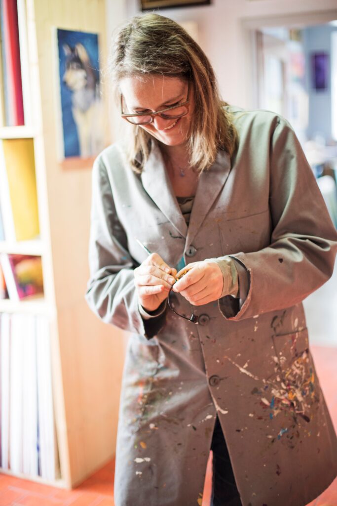 Sabine Thalhammer with brush in hand, painting in her studio in Leutershausen